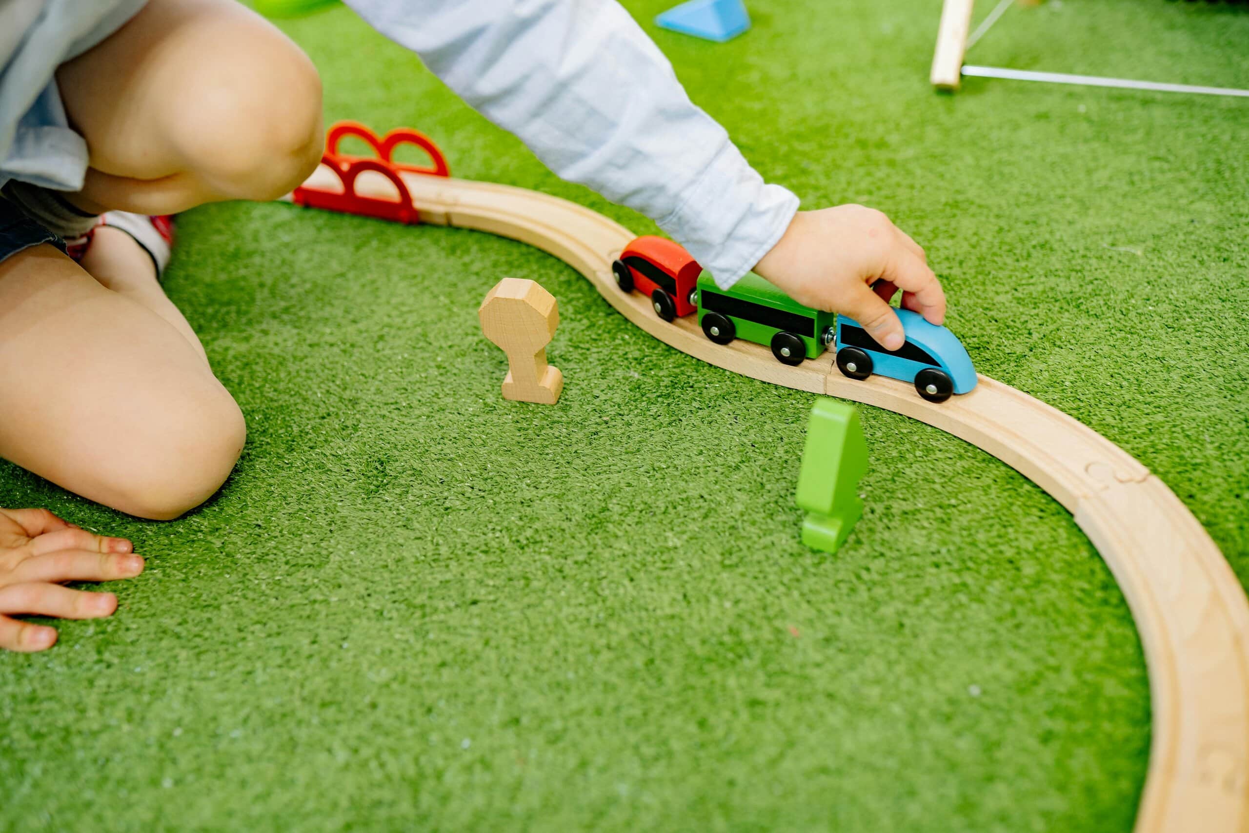 Child playing with wood trains